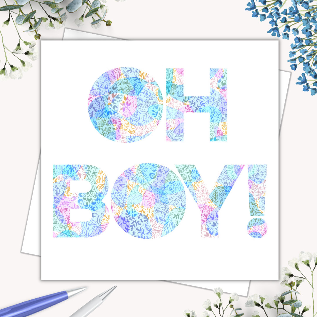 Image shows illustration of the saying OH BOY!. Image is multicoloured with the main colours being pink, blue, yellow, green and purple. Image is laid on a cream surface with many different flowers surrounding it to shown dressed up. 