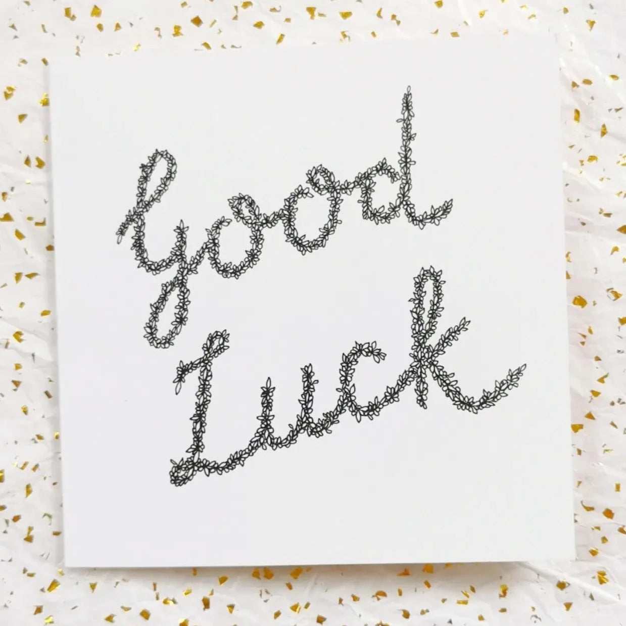 Image shows Good Luck card illustration. Image is made from entirely black and white floral drawings with yellow deigned background. 